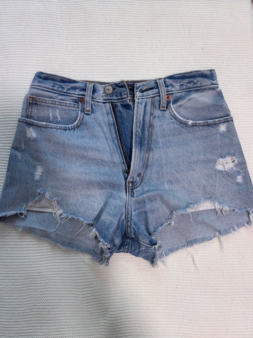 High-Rise Distressed Denim Shorts in Light Blue